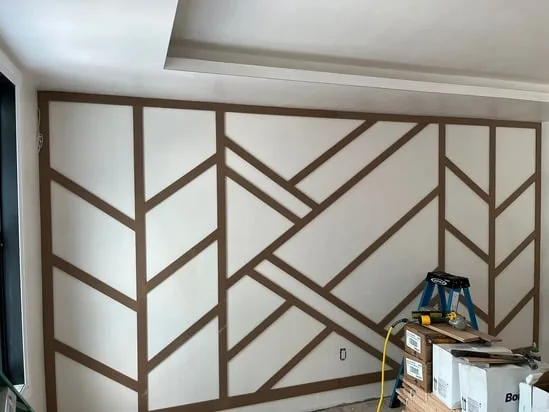 Geometric wood wall trim installation showing aligned decorative pattern.